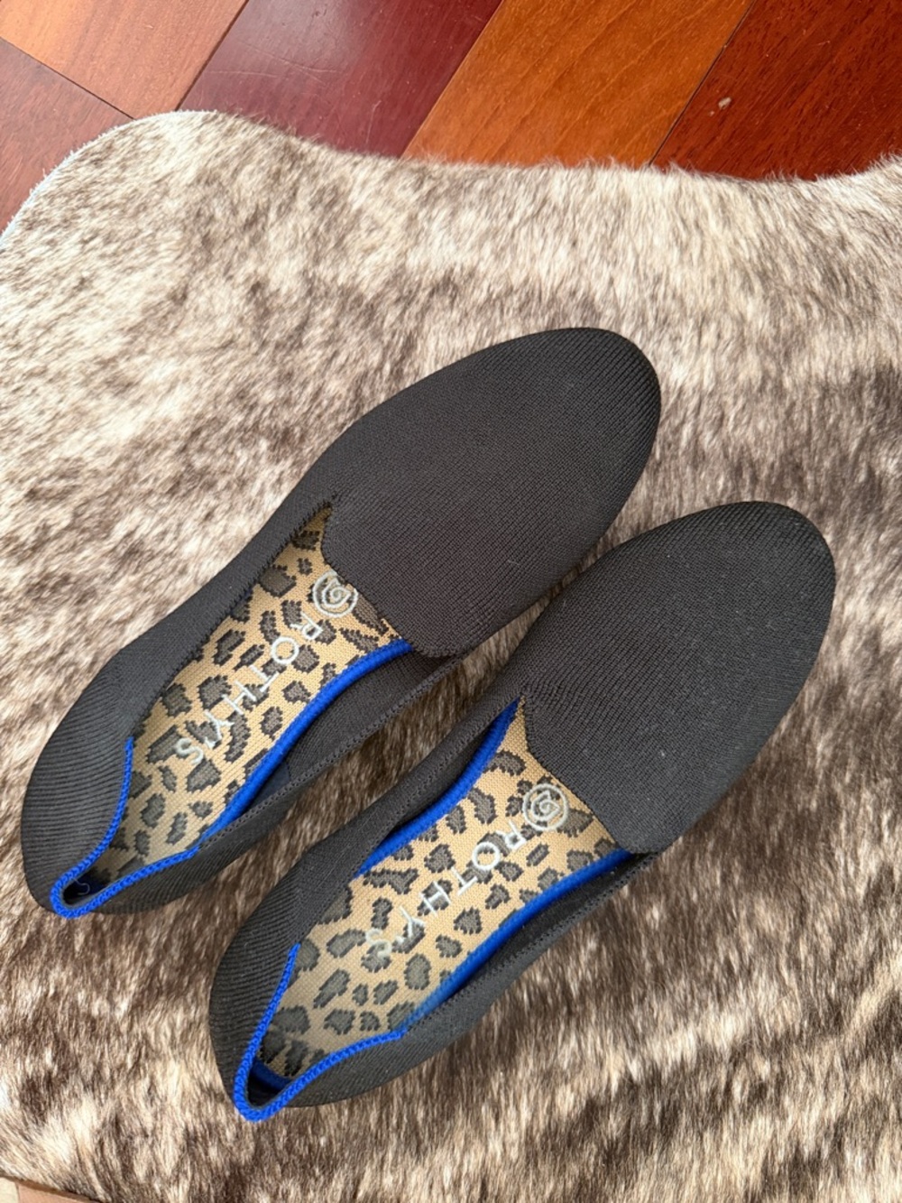 Rothy's Black Knit Slip-Ons with Blue Trim and Leopard Insole